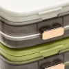 The transparent compartmented medicine box with golden fasteners contains multi-color tablets stacked beside the white and green sealed medicine box Application Scenario